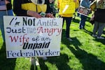 A protestor holds a sign at a No Kings protest in Salt Lake City, UT.