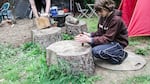 Shea Stephens attempts to build a fire in the backyard of their north Portland house.