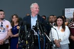 Sen. Chris Van Hollen, D-Md., center, accompanied by Cesar Abrego Garcia, from left, Cecilia Garcia and Jennifer Vasquez Sura, speaks during a news conference upon his arrival from meeting with Kilmar Abrego Garcia in El Salvador, at Washington Dulles International Airport, in Chantilly, Va., Friday, April 18, 2025.