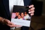 Knightdale, N.C. - March 26th, 2025: Candace Williams, a chief diversity officer who recently lost her job amid corporate America’s DEI retreats, holds a booklet she recieved from her daughters at her 50th birthday party. (Cornell Watson for NPR)