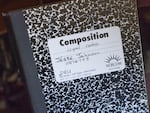 Jesse Johnson pages through a journal he kept while in prison, as Johnson stays in a Portland hotel, Sept. 8, 2023, days after his release from Marion County Jail in Oregon. 