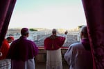Newly elected Pope Leo XIV waves to faithful and pilgrims gathered in St. Peter's Square at the Vatican shortly after his election, Thursday, May 8, 2025. (Vatican Media via AP)
