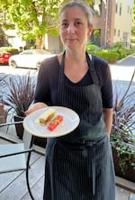 Sarah Pliner holds a pork belly tea sandwich as part of pairing menu she created this past summer for Fullerton Wines. Pliner was the former co-owner of the acclaimed Aviary restaurant. She was killed while riding her bike in Portland on Oct. 4, 2022.