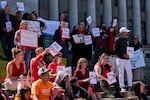 People cheer during a rally advocating for lawmakers to adjust and pass House Bill 1217, a rent-control bill, at the Washington State Capitol Building Friday, April 18, 2025, in Olympia, Wash.