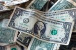 Dollar bills are shown in New York. The Economic Policy Institute says the January 1 minimum wage increases show that the "minimum wage continues to be a powerful tool for combating racial and gender wage disparities."