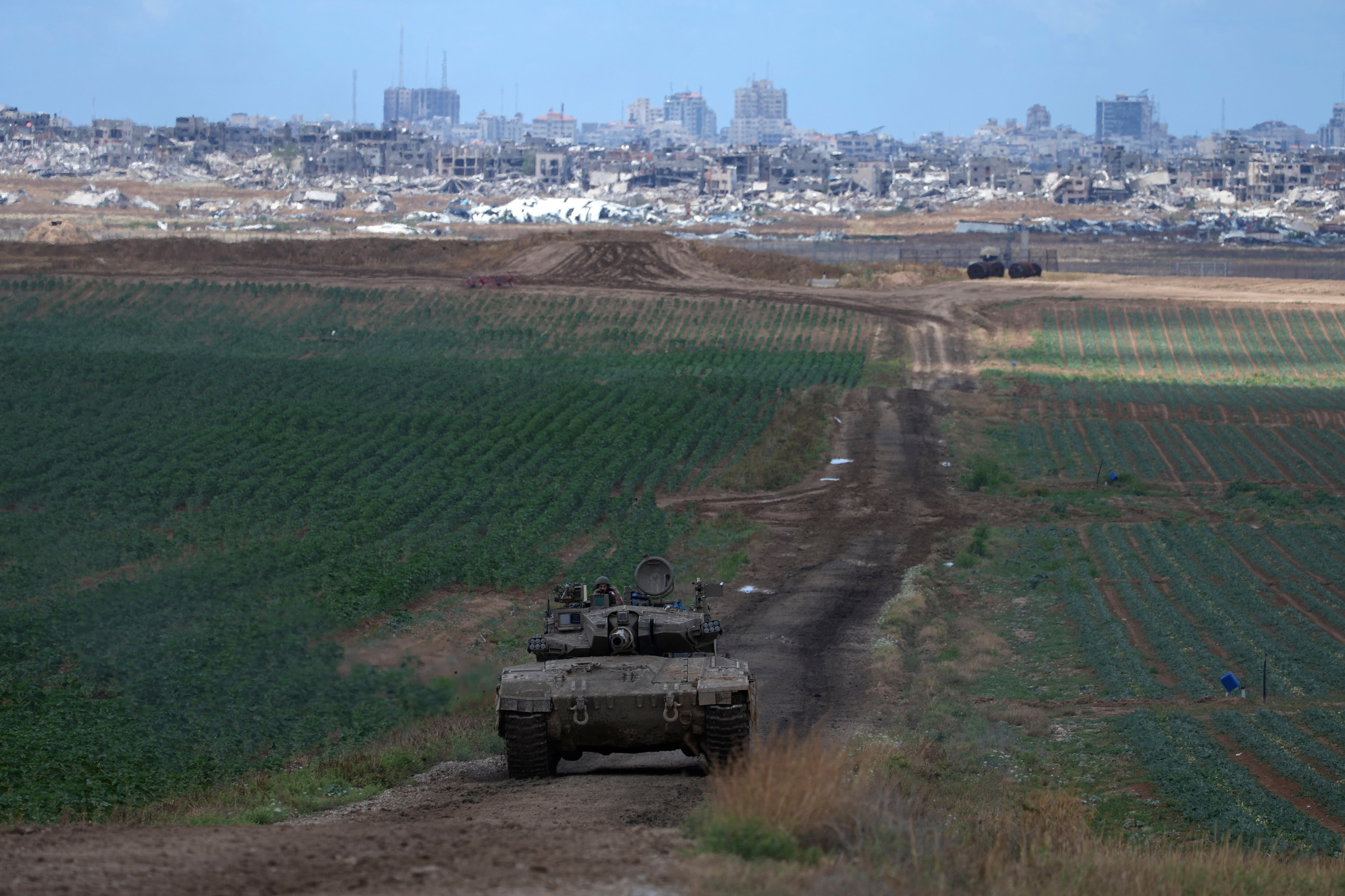 An Israeli Defense Forces tank drives away from the Gaza Strip, as seen from southern Israel, Monday, May 6, 2024.