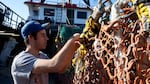 A commercial fisherman in Newport mends a net. 