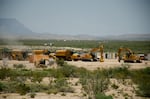 Just north of Big Bend National Park, workcrews clear land for a staging site holding excavators, bulldozers and trailers. CARLOS MORALES FOR NPR