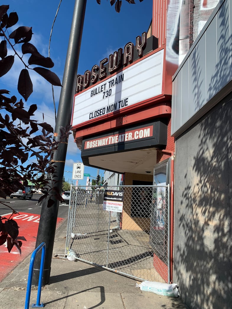 Chain-link fencing can be seen in front of the Roseway Theater in Northeast Portland.