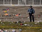 A law enforcement officer looks around the scene after a shooting following the Kansas City Chiefs victory parade in Kansas City, Mo., on Wednesday.