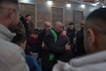 Ashraf Zeghayer (center), a Palestinian who was released from Israeli prison during a ceasefire between Israel and Hamas, hugs his family in their home in Kfur Aqab, East Jerusalem, on Jan. 25.