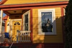 Portlanders pose for window portraits to maintain a proper social distance.