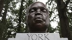 A close up of a sculpture of a man's bust, sitting on a stand that reads "York."