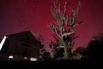 An aurora borealis, also known as the northern lights, glows red in the sky on Oct. 10 in East Derry, N.H.