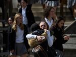 A student from Oakland Catholic High School receives comfort following the evacuation of the school after a call of an active shooter on March 29, 2023 in Pittsburgh, Pennsylvania. Many schools, including Oakland Catholic and Pittsburgh Central Catholic, were targeted as part of what authorities are calling "computer-generated swatting calls." Many agencies, including state and municipal police, are conducting investigations. 