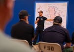 Scott Stearns, meteoroligist with the National Weather Service Storm Prediction Center, attends a fire information meeting in Fossil, Ore., on Tuesday.