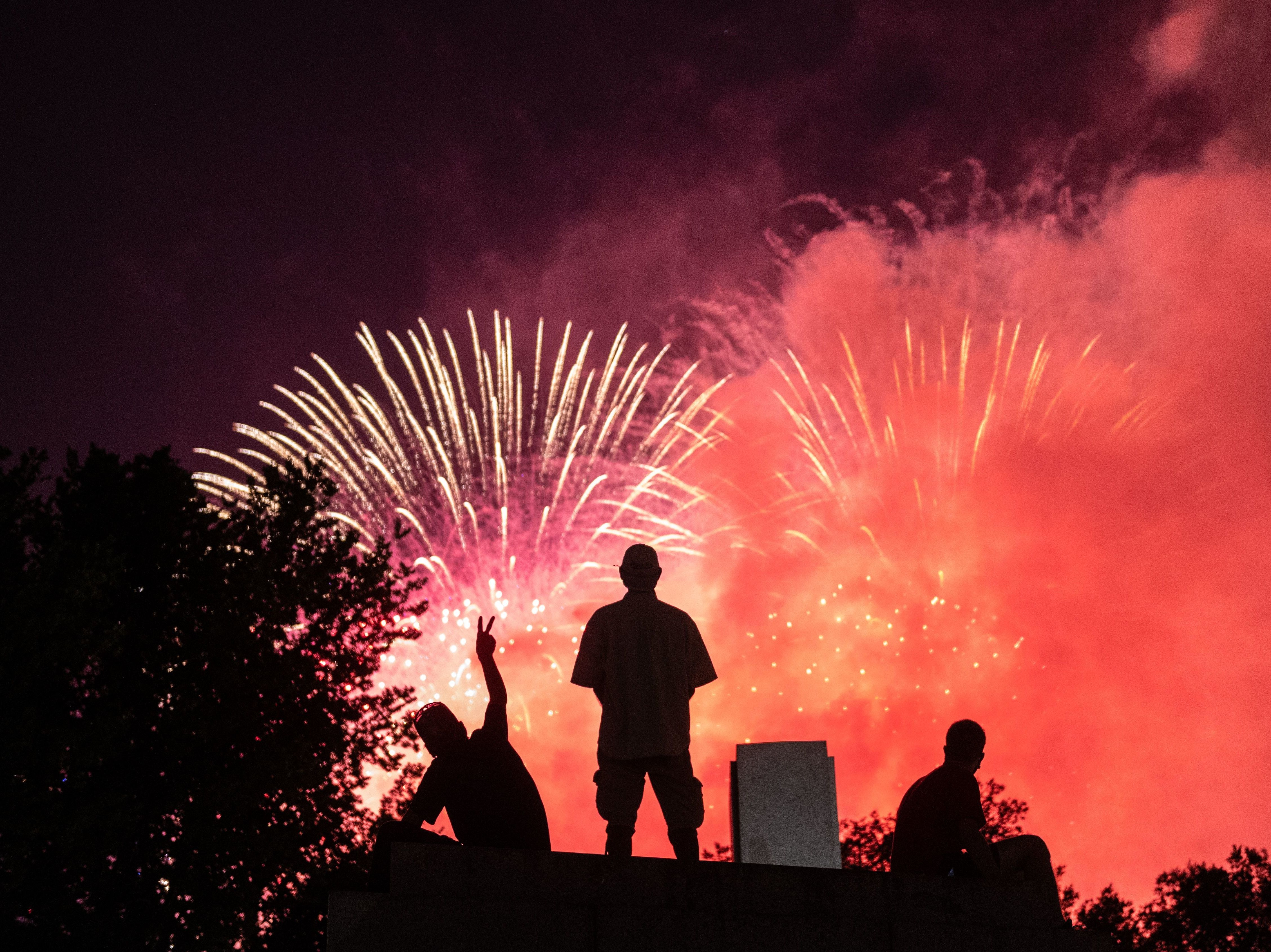 Fireworks are a staple of the Fourth of July and other holidays, but they can frighten animals and pets. Here, spectators at the World War II Memorial watch Independence Day fireworks in Washington, D.C., in 2020.