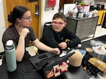 Boyer and Hoy work on some last-minute adjustments to his AI-powered SkoBot before presenting at his school’s end-of-year showcase, called the STEAM Museum.