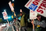 FILE - Boeing employees, including assembler Tyrone Hipolito, center, work the picket line after union members voted to reject a new contract offer from the company, Wednesday, Oct. 23, 2024, in Renton, Wash.