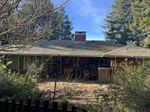 This home's roof is covered in moss and has exceeded its lifespan. NeighborWorks Umpqua later provided a full roof replacement.
