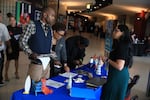 A recruiter speaks with job seekers at a job fair held in Sunrise, Fl., on Sept. 25, 2025.