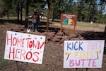 Signs in support of firefighters are posted in front of the fire danger sign and Smokey the Bear statue in Sisters.