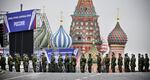 Russian soldiers stand on Red Square in central Moscow on Thursday as the square is sealed off prior to a ceremony for the alleged incorporation of new territories into Russia. Banners on the stage read: "Donetsk, Lugansk, Zaporizhzhia, Kherson — Russia!"