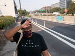 Katherine Morgan wipes sweat from her forehead while walking to work during a record-breaking heat wave in Portland in 2021. President Biden described climate change as a "national emergency" on Wednesday but did not unlock a formal federal response as Oregon Democrats had hoped.