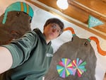Sacha Wells, interpretive ranger for the Nez Perce-Clearwater National Forests, poses in front of the ground squirrel spirit week mural. Tourists have been taking photos in front of the painting all summer long, she said.