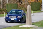 FILE - A car heads into the U.S. from Canada in Peace Arch State Historical Park toward the Peace Arch border crossing Monday, Nov. 8, 2021, in Blaine, Wash.