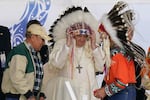 Pope Francis dons a headdress during a visit with Indigenous peoples at Maskwaci, the former Ermineskin Residential School in Maskwacis, Alberta, on July 25, 2022.