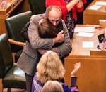Kate Brown hugs Jeff Kruse after Brown was sworn in as Oregon's new governor.