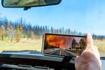 Justin Kostick, forest manager for the Green Diamond timber company, shows a cellphone photo shot when this stretch of trees was burned during the Bootleg Fire in 2021. Today, June 29, 2023, only blackened trees remain. The massive Bootleg Fire destroyed trees in the Klamath Basin, including portions of two carbon offset projects covering 570,000 acres and operated by Green Diamond.