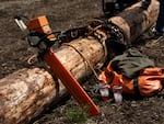 Equipment rests on a log.