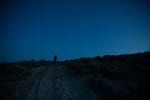 Katie Fite and her dog Bell walk a ranch road toward a sage grouse lek in southeast Oregon on Saturday, April 2, 2022. Male sage grouse perform their mating ritual around daybreak in the springtime.