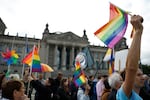 Demonstrators participate in an event called "Show the flag: For queer visibility in the Bundestag!" in front of the Reichstag building that houses Germany's lower house of parliament, the Bundestag, in Berlin, on July 8. The conservative president of the Bundestag said the rainbow flag would no longer be raised on top of the parliament building during Pride month, which in Germany runs from June 28 until July 27.