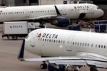 FILE - A Delta Air Lines plane leaves the gate July 12, 2021, at Logan International Airport in Boston. A Delta flight from Seattle to Honolulu was delayed on Tuesday afternoon after an unticketed passenger was discovered onboard the aircraft.