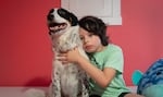 Javi Paz poses with their dog, Poky, in their Southeast Portland home on Aug. 16, 2023. Javier has had Poky for four years and named him after a book, "The Poky Little Puppy."