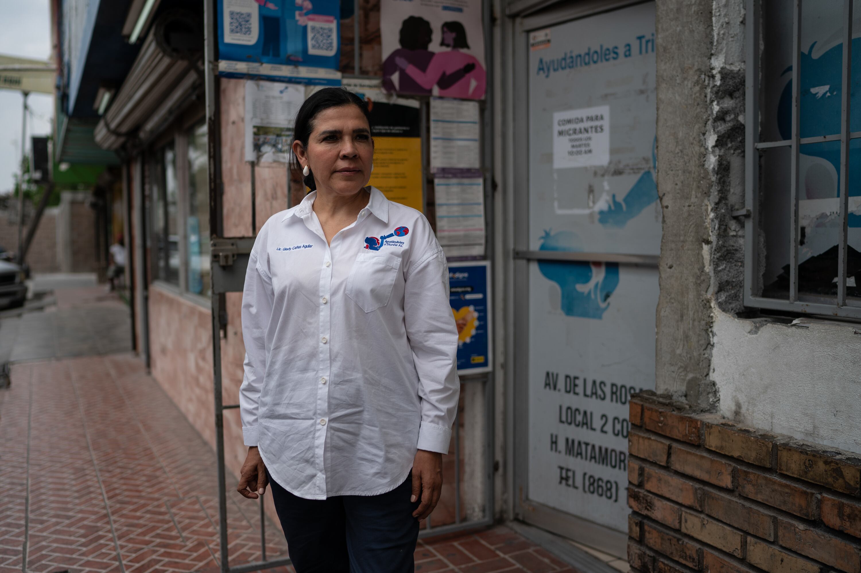 Glady Cañas, president of Ayudándoles a Triunfar, stands outside the organization's offices in Matamoros, Mexico.