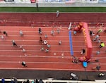 Kids run across the finish line at the Awesome 3000 youth fun run on April 27, 2024, in Salem, Ore.