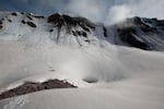 The expedition prepares to descend into "Godzilla Hole" below the crater rim.