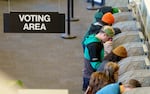 FILE - Voters at the Multnomah County Elections Division in Portland, Ore., Nov. 8, 2022. Oregon voters can vote by mail-in ballot, drop ballots at secure sites, or vote in-person 