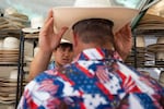 Mark Bailey of the Bent Brim Hat Company helps Jared Hillock choose a hat.