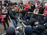 Demonstrators breach security fencing during a protest outside the U.S. Capitol in Washington, D.C., U.S., on Wednesday, Jan. 6, 2021.