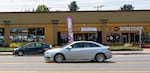 Cars whizz by shops on both sides of Sandy Boulevard, many of which have been in the historic Parkrose neighborhood for years in Portland, Ore., on July 15, 2026.