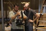 Cinematographer Ryan Lane, left, and director Aaron Toy look at a shot in the camera.