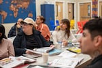 FILE - Iliana Cardenas, left, and Gloria Nuñez, right, who are both originally from Mexico, participate in an adult English language class at B5.