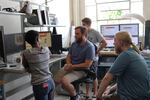 OSU robotics students (left to right) Elizabeth Childs, Kevin Green, Taylor Apgar and Andrew Sanders gather around a computer to research the spring-mass model theory.