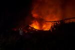 A warehouse fire rages after an Israeli strike in Sidon, Lebanon, on Feb. 19. Several people were injured in Israeli airstrikes south of Sidon a few days before. Israel said it targeted Hezbollah weapons depots, while Lebanese sources reported the attack hit a couple of warehouses. Over 20 people suffered injuries.