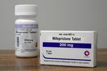 Containers of the medication used to end an early pregnancy sit on a table.